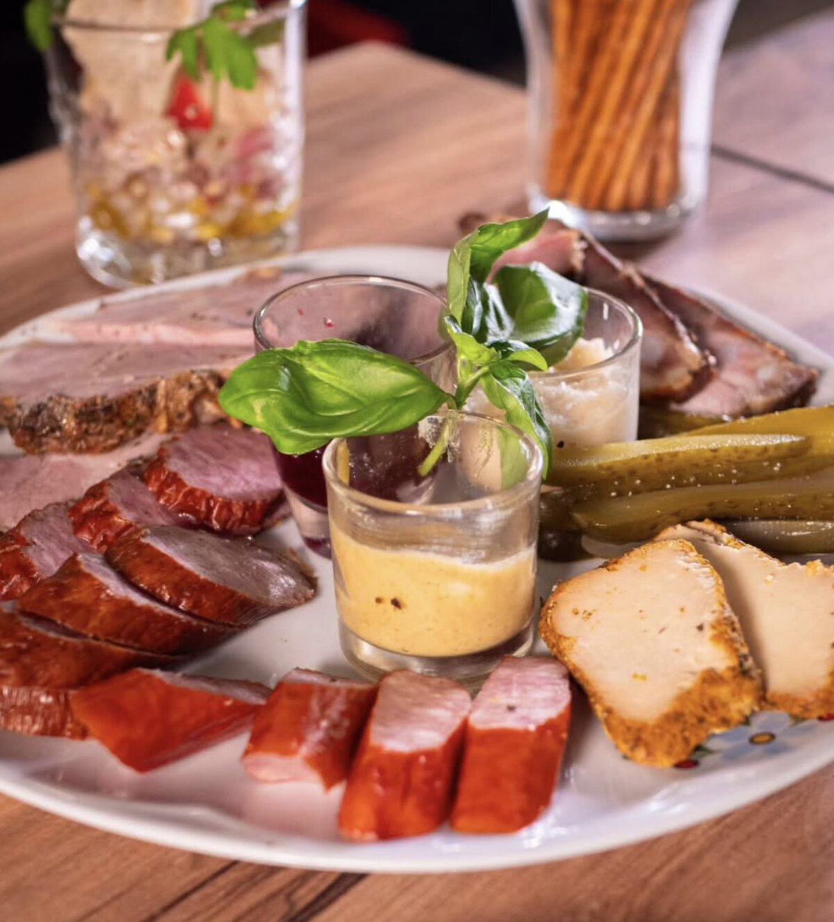 A Polish board of roast meats, sausage and mountain cheese with pickles