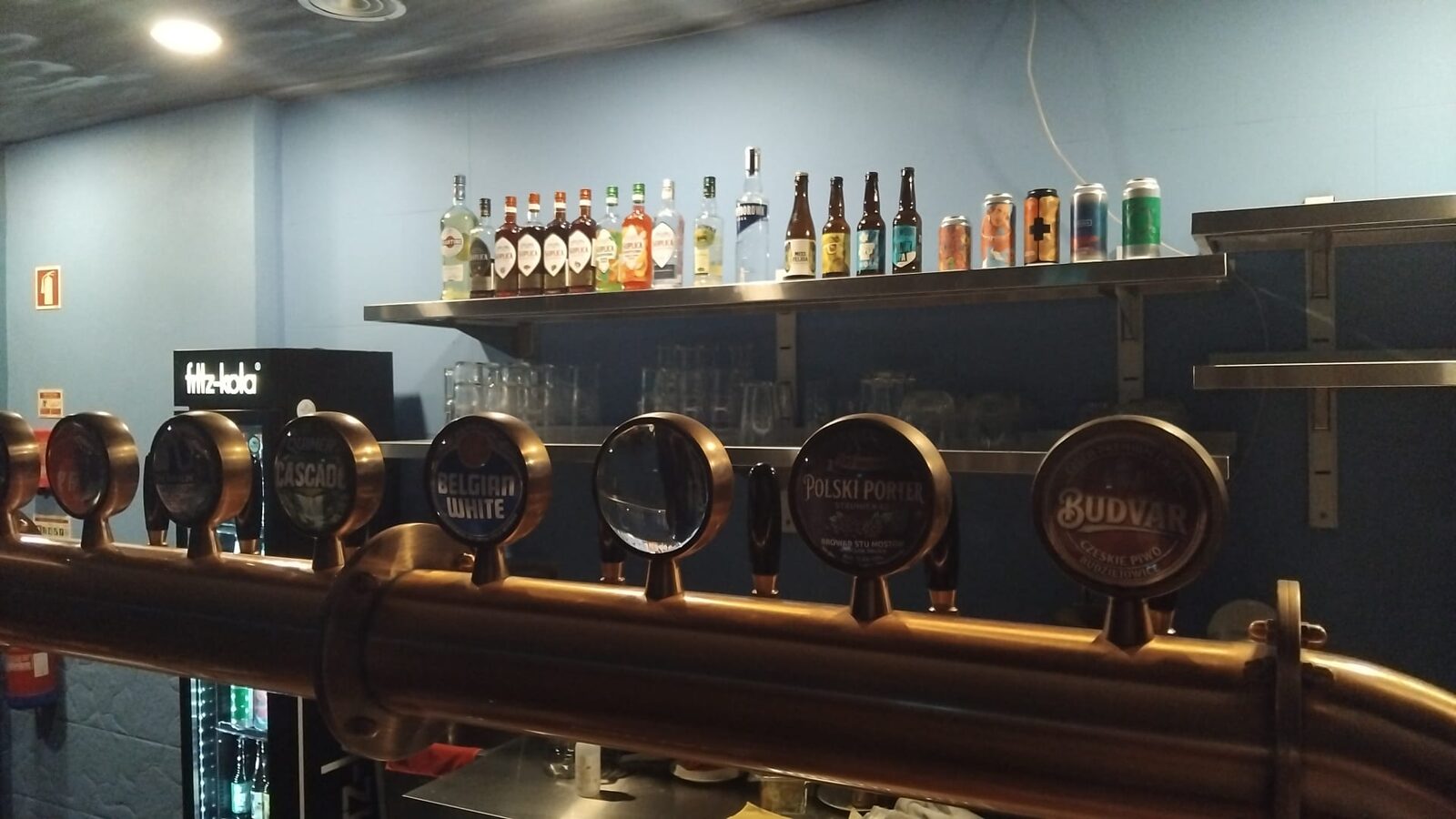 The bar at Pola, the row of taps and Polish spirits on the shelf above